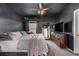 Bedroom with dark walls, a ceiling fan, and a large dresser at 6809 Cobre Azul # 201, Las Vegas, NV 89108