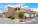 Exterior view of townhome building with two car garages and desert landscaping at 6809 Cobre Azul # 201, Las Vegas, NV 89108