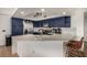 Stylish kitchen with dark blue cabinetry, stainless steel appliances, and marble countertops at 6809 Cobre Azul # 201, Las Vegas, NV 89108