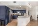 Modern kitchen featuring dark blue cabinets, stainless steel appliances, and a marble countertop island at 6809 Cobre Azul # 201, Las Vegas, NV 89108