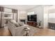 Bright living room with plush sofa, stone fireplace, and access to a covered patio at 6809 Cobre Azul # 201, Las Vegas, NV 89108