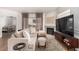 Inviting living room featuring a cozy sofa, stone fireplace, and a mounted TV at 6809 Cobre Azul # 201, Las Vegas, NV 89108