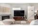 Comfortable living room with a stone fireplace, plush seating, and stylish decor at 6809 Cobre Azul # 201, Las Vegas, NV 89108