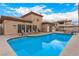 Community pool with lounge chairs, desert landscaping, and clubhouse at 6809 Cobre Azul # 201, Las Vegas, NV 89108