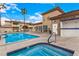 Community pool and jacuzzi with desert landscaping and clubhouse at 6809 Cobre Azul # 201, Las Vegas, NV 89108