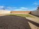 Low-maintenance backyard featuring gravel, minimal grass, and a high fence at 7024 Whispering Falls Dr, North Las Vegas, NV 89084