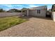 Spacious backyard featuring gravel, partial grass area and block wall for privacy at 7024 Whispering Falls Dr, North Las Vegas, NV 89084