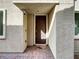 Inviting front entrance with a covered porch, brick walkway, and modern lighting at 7024 Whispering Falls Dr, North Las Vegas, NV 89084