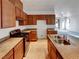 Modern kitchen showcasing wood cabinets, stainless steel appliances, and granite countertops overlooking the living area at 7024 Whispering Falls Dr, North Las Vegas, NV 89084