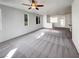 Spacious living room featuring carpet flooring and ample natural light from the large windows at 7024 Whispering Falls Dr, North Las Vegas, NV 89084