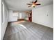 Expansive living room with plush carpeting, abundant natural light, and seamless flow into the kitchen area at 7024 Whispering Falls Dr, North Las Vegas, NV 89084