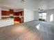 Open concept living space with a kitchen, living room, and sliding glass door at 7024 Whispering Falls Dr, North Las Vegas, NV 89084