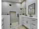 Modern bathroom features a glass enclosed shower, sleek vanity with black hardware, and clean, contemporary design at 7413 Turtle Dove Ct, Las Vegas, NV 89129