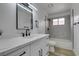 Modern bathroom with sleek vanity, black fixtures, and a shower/tub combo, providing a stylish and functional space at 7413 Turtle Dove Ct, Las Vegas, NV 89129