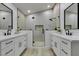 Modern bathroom with dual vanity sinks, frameless shower, and sleek black fixtures at 7413 Turtle Dove Ct, Las Vegas, NV 89129