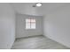 Clean bedroom with a window providing natural light, complemented by neutral wall tones and modern flooring at 7413 Turtle Dove Ct, Las Vegas, NV 89129