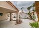 Covered carport featuring an open design with stucco columns and a winding driveway lined with desert landscaping at 7413 Turtle Dove Ct, Las Vegas, NV 89129