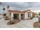 Single-story home featuring a stucco exterior, a red tile roof, covered patio, and circular windows at 7413 Turtle Dove Ct, Las Vegas, NV 89129