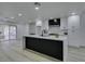 Contemporary kitchen with large center island, white cabinets, and sliding glass doors to the backyard at 7413 Turtle Dove Ct, Las Vegas, NV 89129