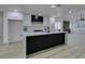 Modern kitchen with white cabinets, black island, stainless steel appliances, and open floor plan at 7413 Turtle Dove Ct, Las Vegas, NV 89129