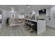 Spacious kitchen with a central island, white cabinets, modern appliances, and an open dining area at 7413 Turtle Dove Ct, Las Vegas, NV 89129