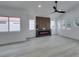Living room featuring a modern fireplace and large windows at 7413 Turtle Dove Ct, Las Vegas, NV 89129