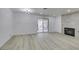 Open living room with sliding glass doors and fireplace at 7413 Turtle Dove Ct, Las Vegas, NV 89129