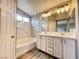 Modern bathroom features dual sinks, marble accents, and a soaking tub at 7696 Mocorito Ave, Las Vegas, NV 89113