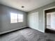 Bedroom with neutral walls, carpet, window, and closet at 7696 Mocorito Ave, Las Vegas, NV 89113