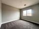 Bedroom with neutral walls, carpet, and large window at 7696 Mocorito Ave, Las Vegas, NV 89113