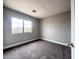 Empty bedroom with neutral walls, carpet, and a large window at 7696 Mocorito Ave, Las Vegas, NV 89113