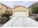 Exterior view of the home's two car garage and long driveway at 7696 Mocorito Ave, Las Vegas, NV 89113
