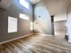 Bright living room features wood flooring, many windows, and high ceilings for an airy feel at 7696 Mocorito Ave, Las Vegas, NV 89113