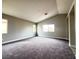 Spacious bedroom offers plush carpet, a neutral color palette, and multiple windows at 7696 Mocorito Ave, Las Vegas, NV 89113
