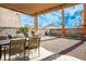 The backyard offers a dining space and grill area, with a graveled landscape and clear blue sky at 7820 Esteem St, Las Vegas, NV 89131