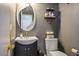 Powder room featuring vanity with modern fixtures, toilet and mirrored wall decor at 7820 Esteem St, Las Vegas, NV 89131