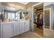 Bathroom features double sinks, vanity, large mirror, and well-organized walk-in closet at 7820 Esteem St, Las Vegas, NV 89131