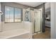 Bright bathroom with a large tub and separate shower, alongside a window view at 7820 Esteem St, Las Vegas, NV 89131