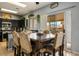 Dining area featuring dark wood table, chairs, and view of the backyard patio through sliding glass doors at 7820 Esteem St, Las Vegas, NV 89131