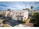 Two-story home boasts a tiled roof, two-car garage, manicured landscaping, and mature palms under a partly cloudy sky at 7820 Esteem St, Las Vegas, NV 89131