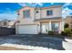 Charming two-story home with a well-manicured lawn, and a two-car garage nestled under a bright blue sky at 7820 Esteem St, Las Vegas, NV 89131