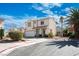 Inviting two-story home with a neatly landscaped yard, complemented by a mature palm tree and a two-car garage at 7820 Esteem St, Las Vegas, NV 89131