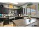Updated kitchen boasts stainless steel appliances, dark cabinetry, and granite countertops at 7820 Esteem St, Las Vegas, NV 89131