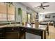 Kitchen with stainless steel appliances, dark cabinetry, and dining area with a ceiling fan at 7820 Esteem St, Las Vegas, NV 89131