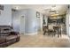 Open concept living and dining area featuring tile floors and dark wood dining set at 7820 Esteem St, Las Vegas, NV 89131