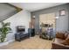 A comfortable living room features tile flooring, a wet bar, a large window, and neutral paint at 7820 Esteem St, Las Vegas, NV 89131