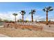 Sign for Atlas Park surrounded by gravel and palm trees on a bright day at 7828 Stone Forest St, North Las Vegas, NV 89084