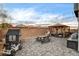 This backyard features a patio with multiple seating areas, playhouse, and picnic table at 7828 Stone Forest St, North Las Vegas, NV 89084