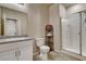 Bright bathroom featuring a glass shower, tile floors, and granite countertop at 7828 Stone Forest St, North Las Vegas, NV 89084