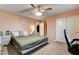 Comfortable bedroom featuring a ceiling fan, plush carpeting, and lots of natural light at 7828 Stone Forest St, North Las Vegas, NV 89084